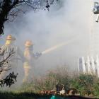 Fire crews work to put out a blaze in an unoccupied house in Lune St, Oamaru, yesterday. Photos...