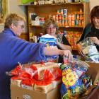 Mosgiel Foodbank volunteers Julie Eaton (left) and Kerrie Russell (right) help foodbank co...