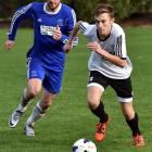 Roslyn-Wakari’s Nathan Wilkie (right) looks to move the ball ahead of Mosgiel’s Harley Rodeka in...