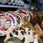 Souvenir plates depicting Syria's President Bashar al-Assad and Russia's President Vladimir Putin...