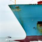 The container ship Maersk Brani, carrying Otago produce, leaves Otago Harbour; background, the in...