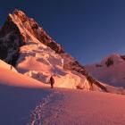Ben Dare approaches the east face of Taulliraju, Peru, during the first ascent of the peak's East...