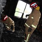 Central-North Otago Fire Risk Management Officer Stuart Ide (left) investigates the cause of a...