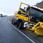 A Downer grit truck sits in a ditch on State Highway 87 between Outram and Sutton yesterday....