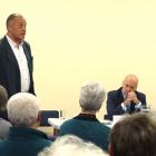 Central Otago mayoral candidate Martin McPherson (left) speaks as Tim Cadogan (centre) and Tony...