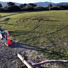 A broken fence and skid marks at Kettle Park where police discovered a burnt-out Nissan shortly...