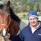 Wingatui trainer Terry Kennedy with a 2yr-old Rock 'n' Pop-Read My Lips filly at his stables on...