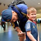 Young Highlanders fan Beau Glover (4) gets his jersey signed by winger Patrick Osborne at Dunedin...