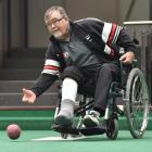 Ken Walker bowls from a wheelchair during the world indoor qualifying singles tournament at the...