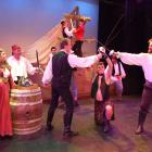  In the midst of swashbuckling action in a rehearsal for the Pirates of Penzance are (front, from...