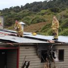 Firefighters from Bluff and Invercargill check for hot spots after extinguishing a fire at the...