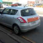 A Dunedin City Council vehicle parked on yellow lines, over a fire hydrant, and next to a bus...