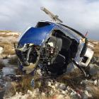 The wreckage of a helicopter that tipped over while landing on Mt Sale, on the Crown Range, on...