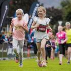 Scarlett Williams (right) and a friend pace their way to the finish line in the 2015 Kids' Run,...