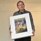 Arts Festival Dunedin silent auction winner Aalbert Rebergen holds his new painting. Photo by...