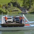 Tuapeka Mouth Ferry operators Niel Sowry (left)  and Terry Stride guide a precious load of Minis...