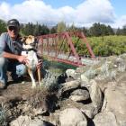 Luggate Community Association chairman Graeme Perkins and his dog Mac look over the damage done...