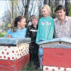 Louise, Jack, Briar and Reece Adamson examine unused beehives at their Earnscleugh home. Photo:...