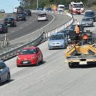 Downer staff work on the resealing the Southern Motorway at Saddle Hill last month. Photo by...