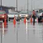 Downer staff drain water from Portsmouth Dr in Dunedin yesterday. Photo by Stephen Jaquiery.