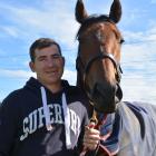 Co-trainer Matthew Pitman holds  First Serve, the stable’s big hope for the Pegasus Stakes at...