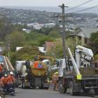 Linemen work to replace a red-tagged pole in Argyle St, Mornington, after it was struck by a...