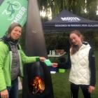 Bike'vember volunteer Babu Blatt (left) hands Samantha Burke her Bike'vember passport at the...