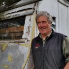 Warbirds over Wanaka volunteer Graham Taylor inspects an old caravan which could be part of one...