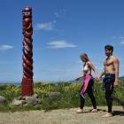 Georgia Manera (22), of Haast, and Angus Mackenzie (21), of Dunedin, walk past the new pou at...