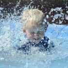 Toby Gullen-Baker (2) takes the plunge and cools down with a splash in the paddling pool at...