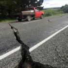 A truck drives over the fractured road caused by an earthquake south of the town of Ward. REUTERS...