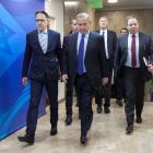 Israeli Prime Minister Benjamin Netanyahu (centre) arrives at the weekly cabinet meeting at his...