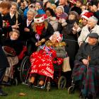 Prince Harry greets well wishers as he leaves the Christmas Day church service in Sandringham....