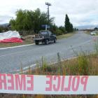 A tarpaulin covers the motorcycle on which Scott Alexander Mackenzie crashed early yesterday, in...