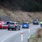 Cars on Queenstown's Gorge Rd, near Industrial Pl, snake past a car that crashed in icy...
