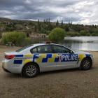 A police car parks at the Bannockburn inlet, the Kawarau arm of Lake Dunstan. Photo: Jono Edwards