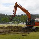 A digger works on a sports field at Logan Park yesterday. Photo by Gerard O'Brien.
