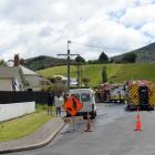 Firefighters at the scene of a fire in Mill St at Sawyers Bay. Photo: Linda Robertson