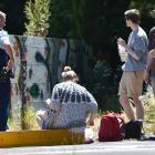Police speak to a group of young people about painting on a derelict wall at the intersection of...