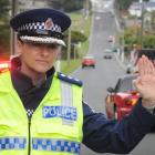 Southern road policing manager Inspector Tania Baron stops traffic in Dunedin’s Eglinton Rd this...