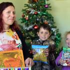 Danielle Culling and her children Felix and Alba put presents in a box in their Dunedin home to...