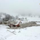 Rescue workers work with an excavator at the site of the avalanche-buried Hotel Rigopiano in...