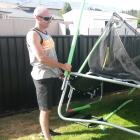 Nathan Manning, of Cromwell, helps move a trampoline destroyed by a tornado at his friend's house...