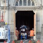 A remote control-operated machine works below floor level at Dunedin's historic courthouse in...