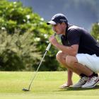 Duncan Croudis (Otago) lines up his putt on the 18th hole during the New Zealand Open regional...