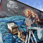 Artist Guy Howard-Smith works on his mural in Castle St yesterday. PHOTO: STEPHEN JAQUIERY