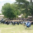 Mourners gather as two helicopters prepare to lift the casket of Cromwell teacher Anne Cook from...