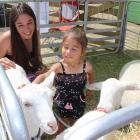 Jessica and daughter Jahleigha (2) Nichol, both of Alexandra, play with goats at the Central...