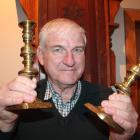 Prof Brian Roberts holds a set of candlestick holders which his ancestors salvaged from the wreck...