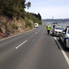 Police interview people after a campervan and cyclist collided in Dunedin today. Photo: Shawn McAvinue